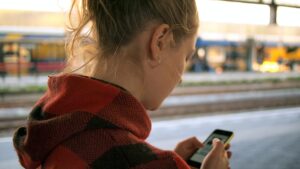 woman staring at her cell phone